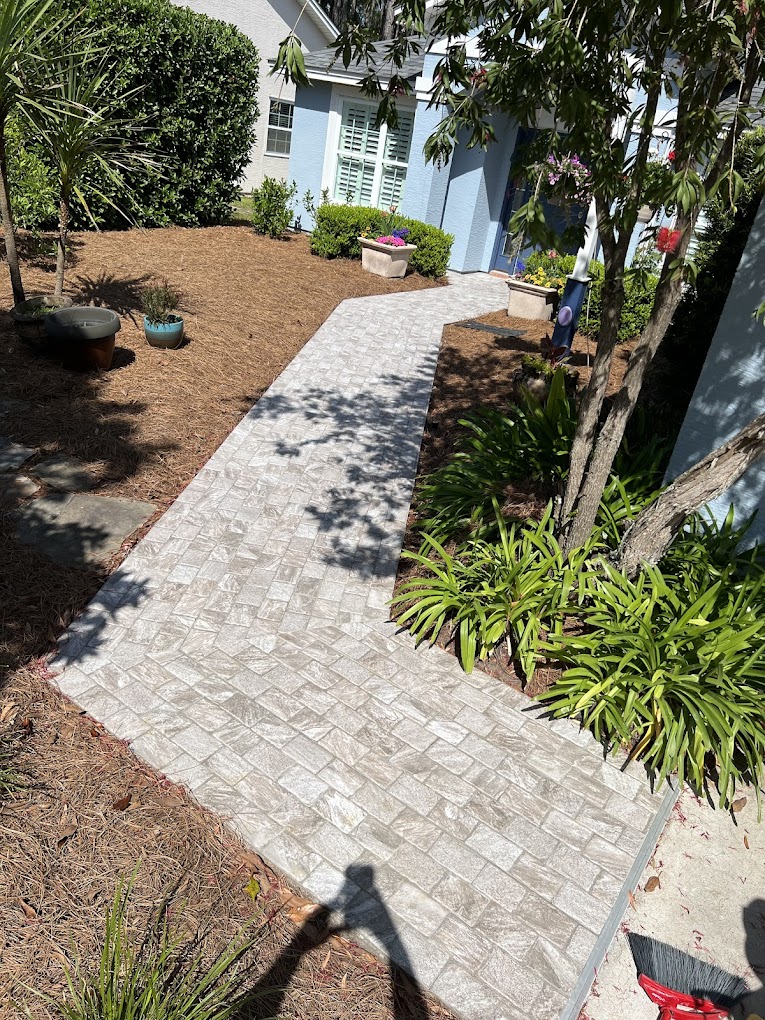 Curved stone paver walkway through garden landscaping.